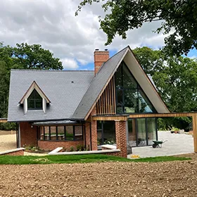 A house with a large yard in front of it.