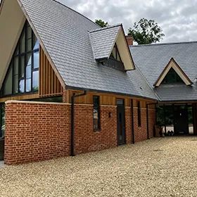 A large brick building with a black roof.